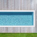 Modern house with garden swimming pool and wooden deck